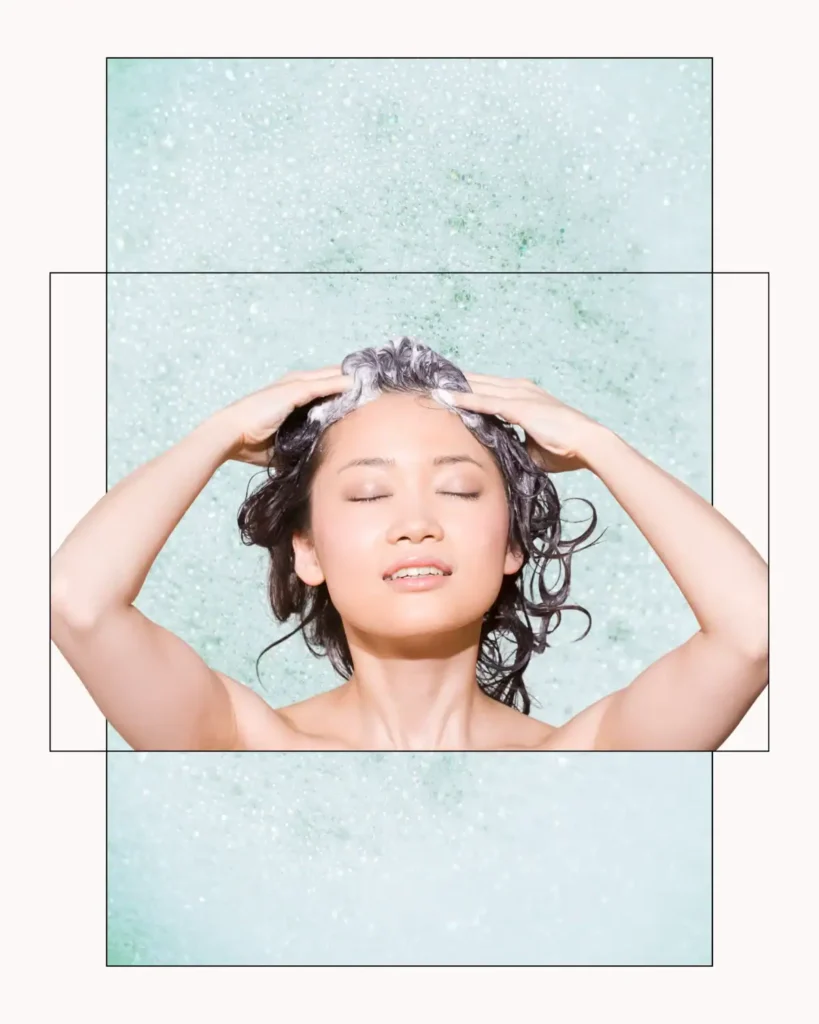 Asian woman lathering her hair