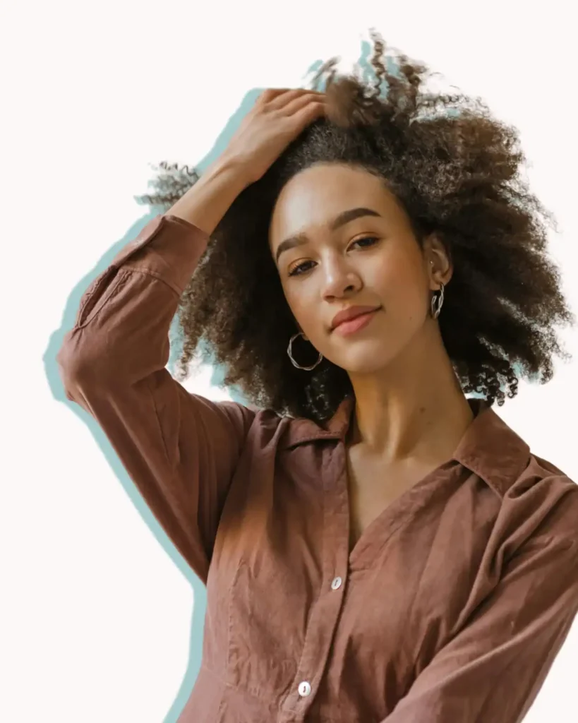 woman with an afro touching her hair