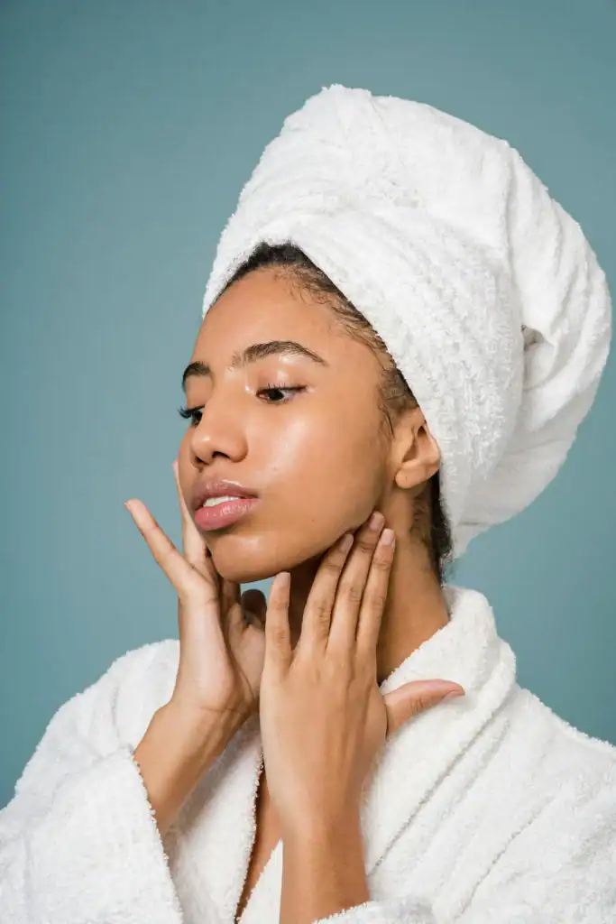 woman-in-a-gown-touching-her-face.-skincare-concept-683x1024