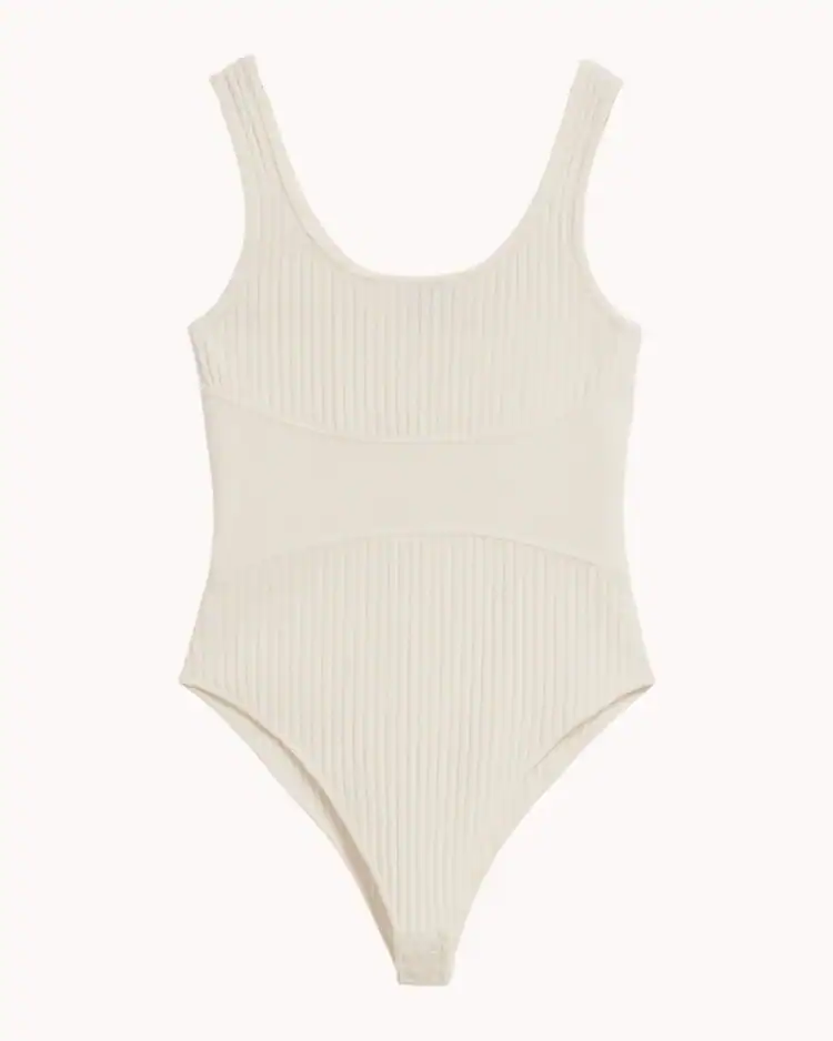 Cream+ribbed+bodysuit+on+a+plain+beige+background