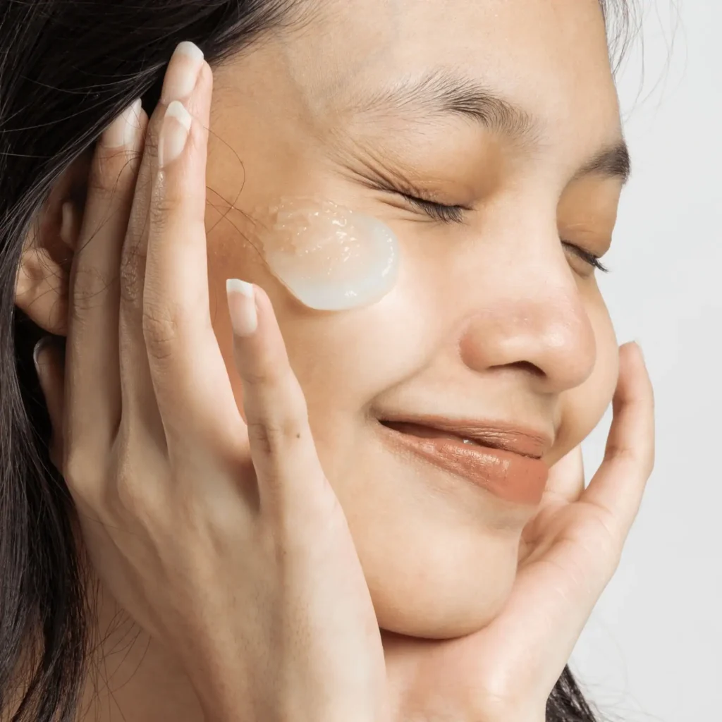 Closeup Portrait of Smiling Woman with Moisturizer. Slugging Skincare Trend