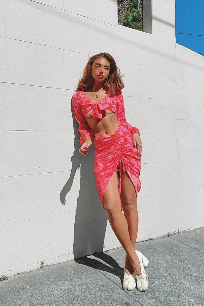 young woman wearing pink crop top and skirt coord with white tabi shoes