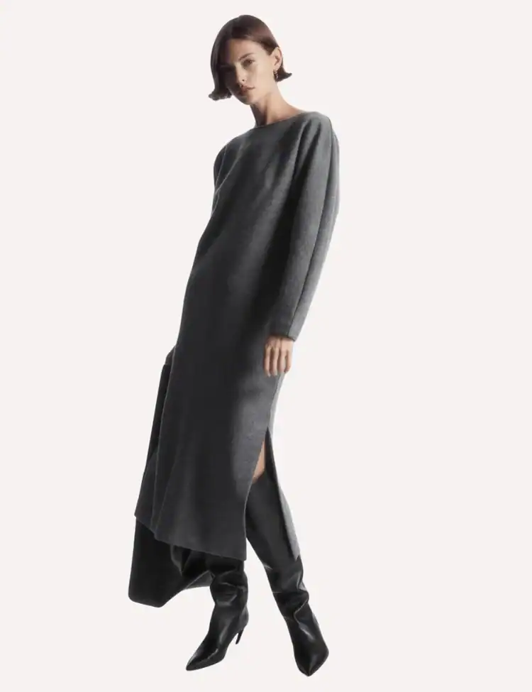 Model poses wearing a grey knit maxi dress