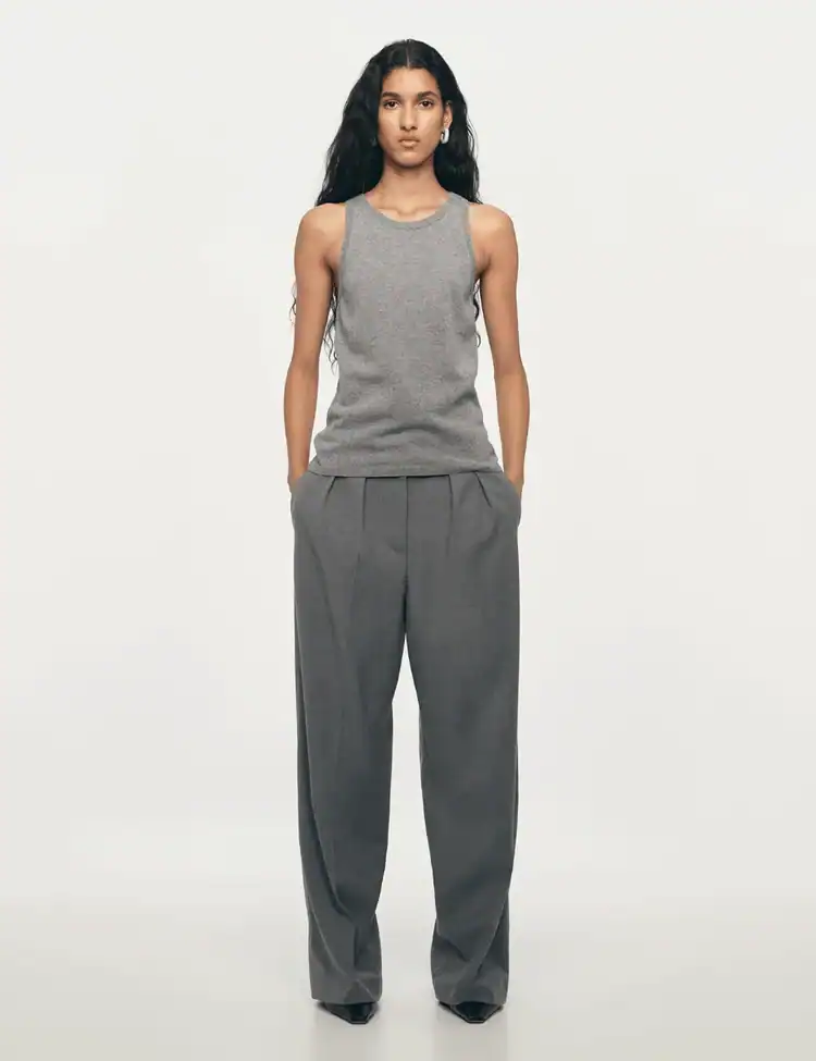 model wearing low waist grey flannel trousers. TikTok’s ‘Groutfit’ Trend