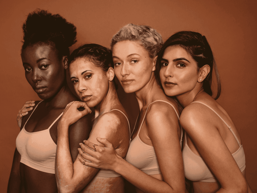 four women with different skin tones with hyperpigmentation