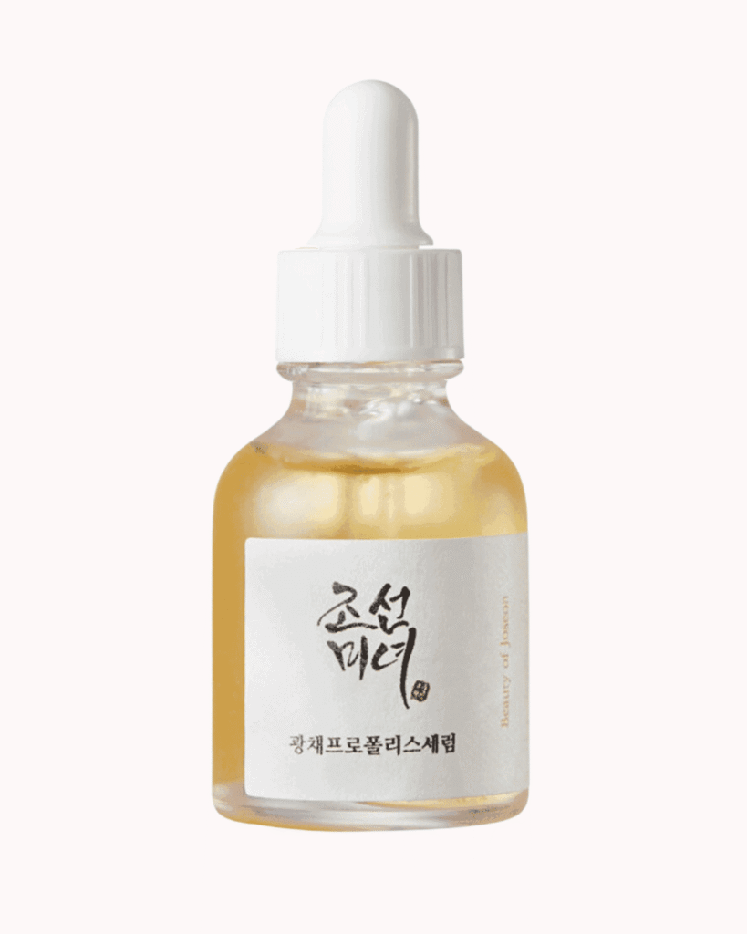 Beauty of Joseon glow serum on a plain pastel pink background