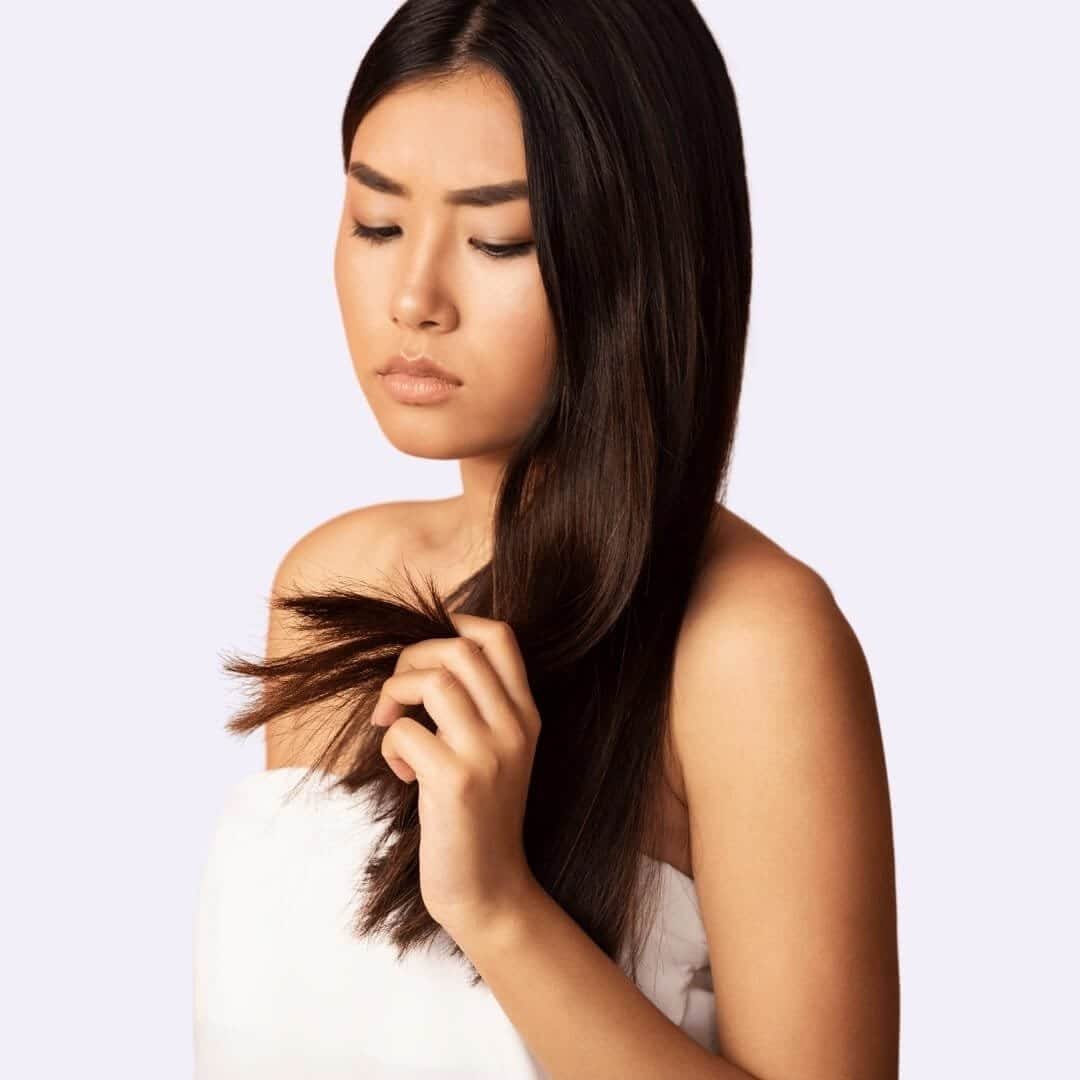 Woman Holding Damaged Split Hairs. Best Deep Conditioners For High Porosity Hair