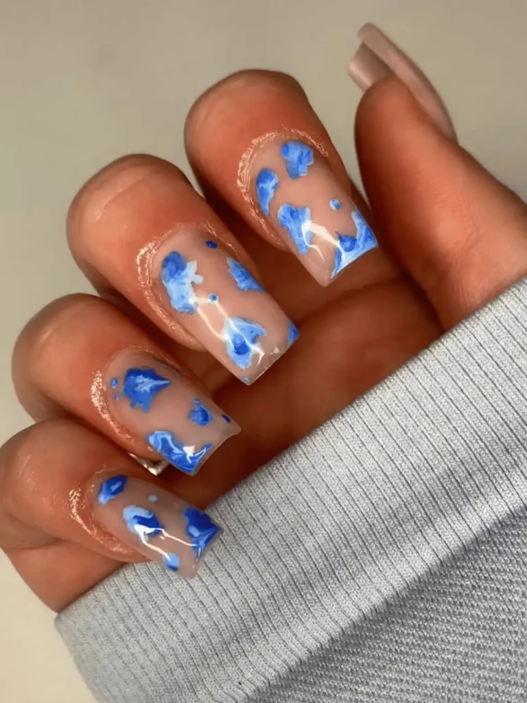 Blue swirl cow print nails