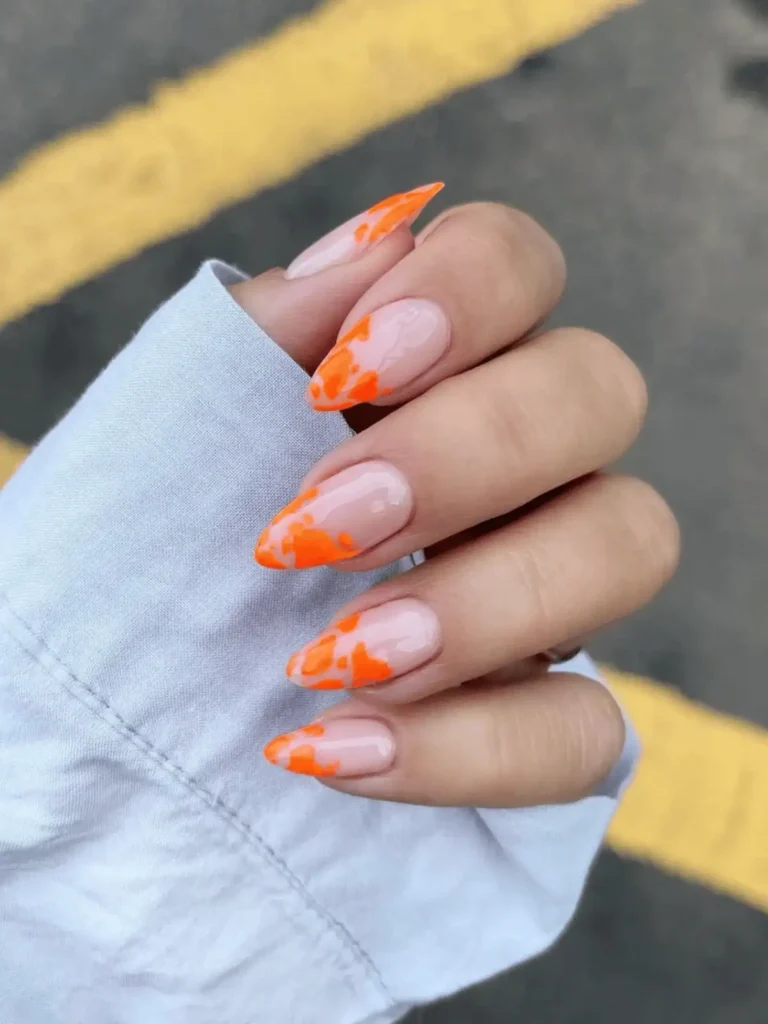 orange cow print almond nails