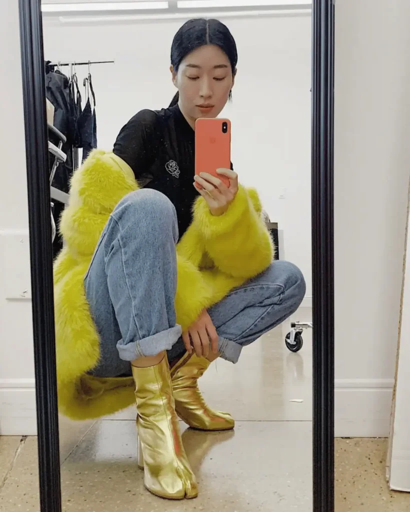 Asian women wearing a yellow fluffy coat with gold tabi shoes