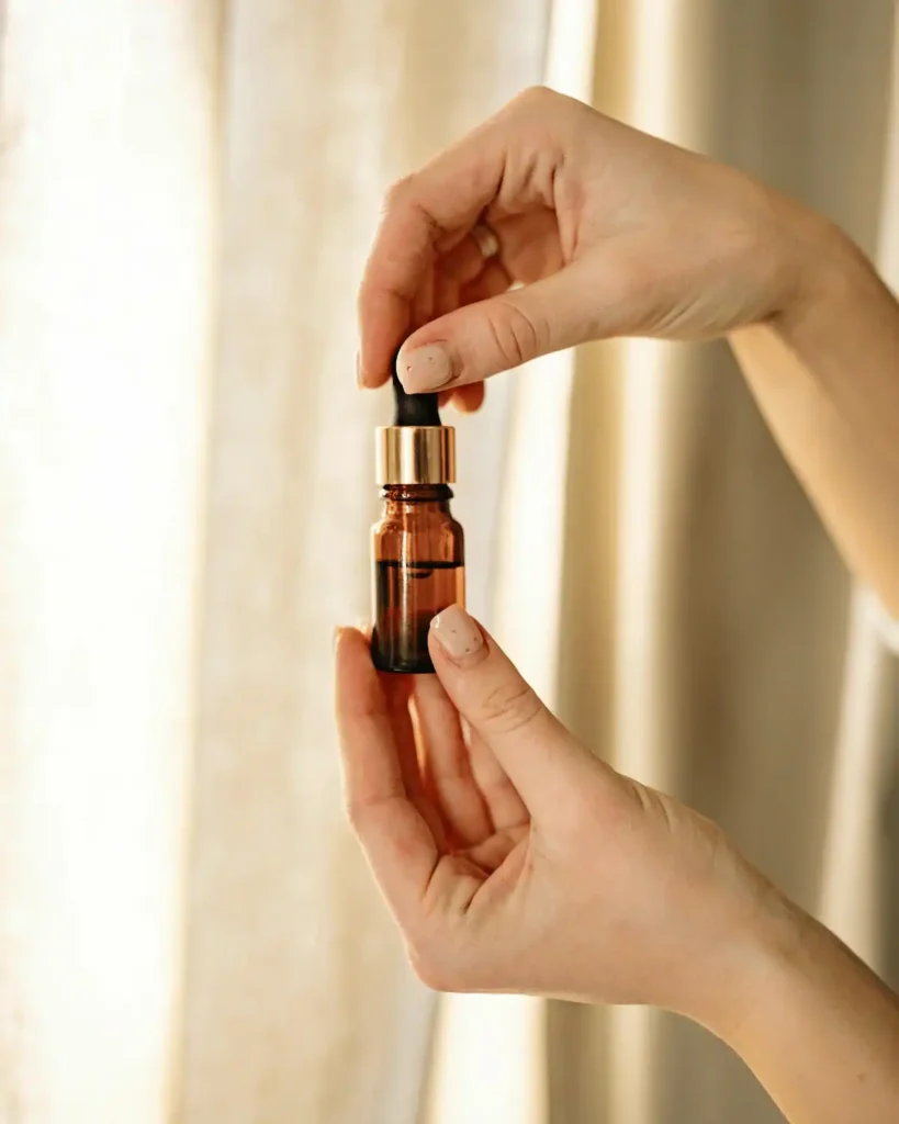 hands holding a bottle of argan oil. Argan Oil For Eyelashes