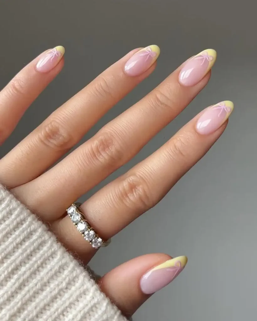 Pastel yellow tip nails with bows