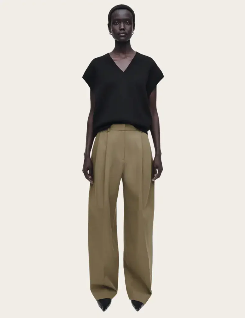 model wearing black v-neck short sleeve top and khaki linen trousers