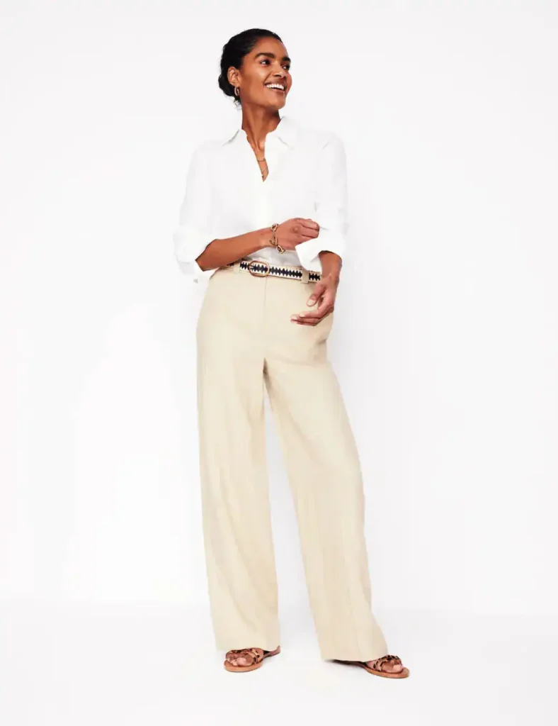 model wearing white blouse and pastel yellow trousers