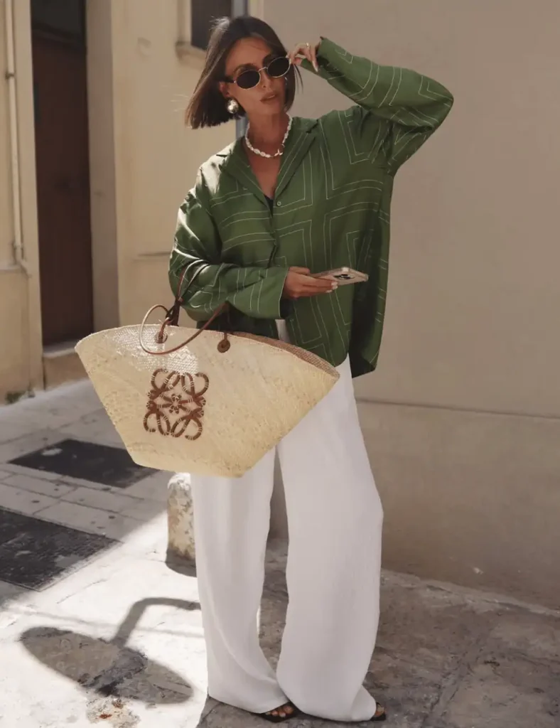 young woman with short brown hair wearing a loose-fitter green shirt with linen trousers. old money outfit ideas for women