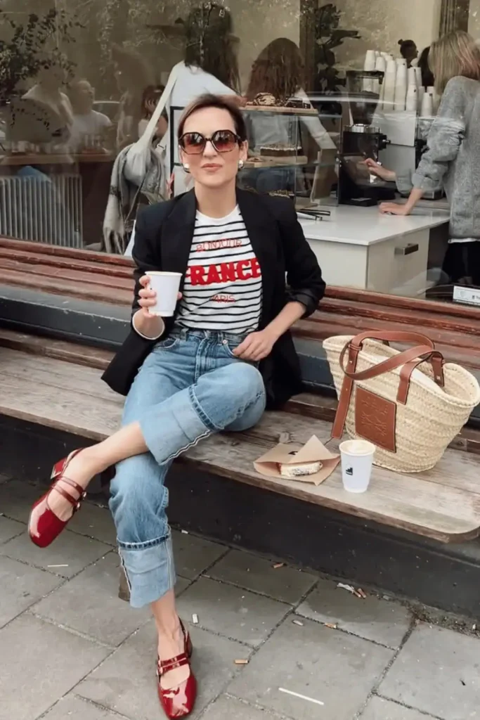 women weaing a black blazer, red Mary janes, white shirt