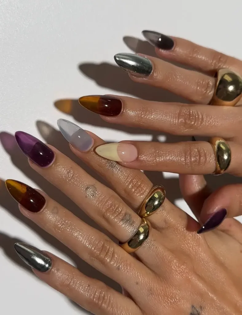 Mismatched manicure with chrome, tiger's eye, purple, and yellow nail designs.