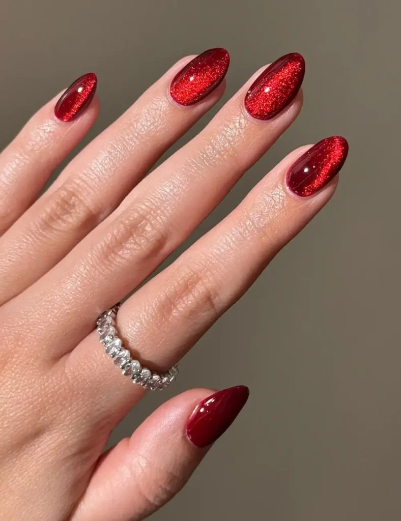 Almond nails with a shimmering red velvet cat eye finish
