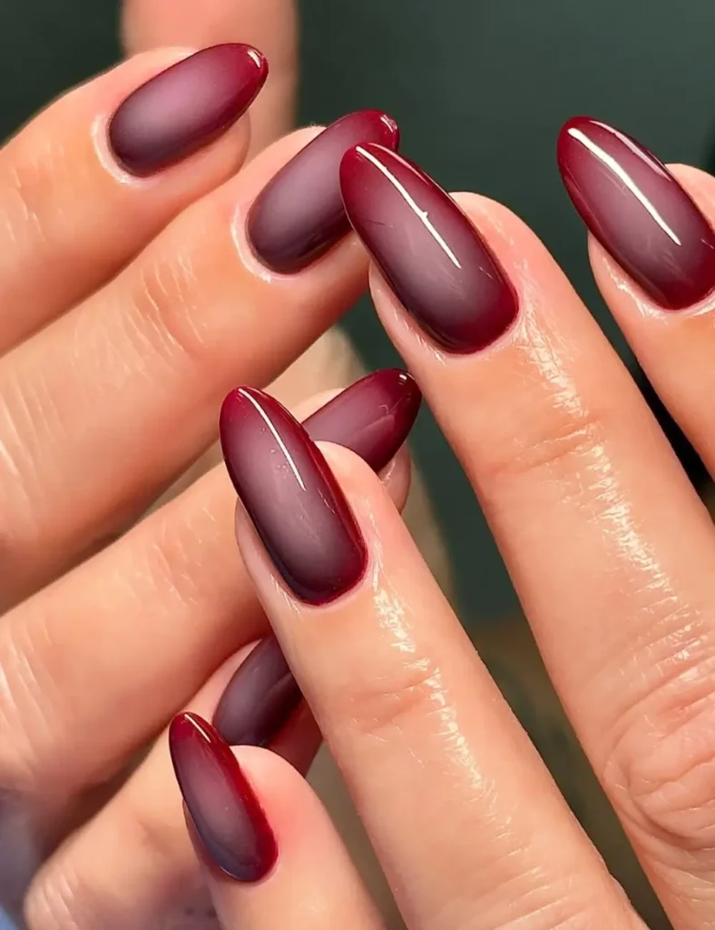 Almond nails with a soft mauve center blending into deep burgundy edges