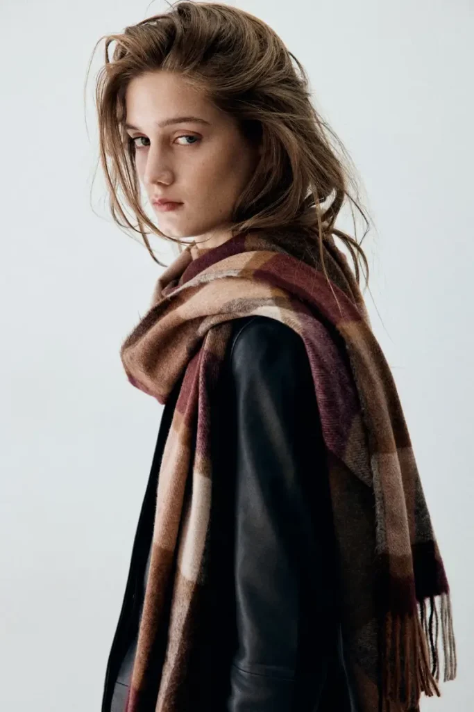 Burgundy, brown, and beige plaid Mango scarf with fringed ends, draped over a dark jacket