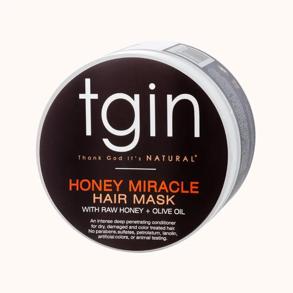 Jar of tgin Honey Miracle Hair Mask deep conditioner with raw honey on a plain background