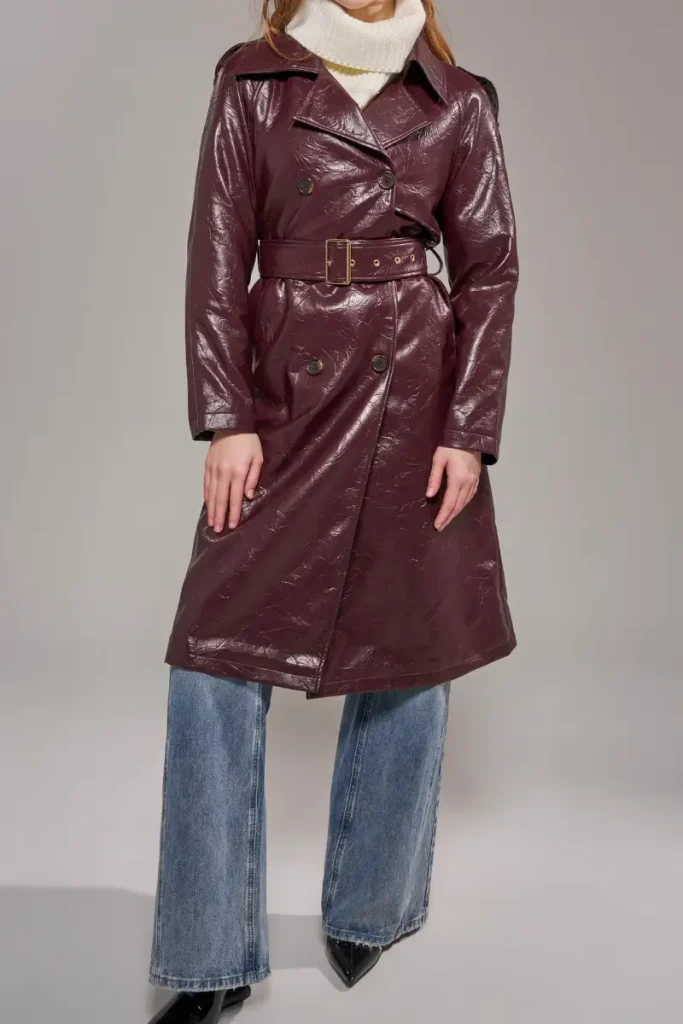 Woman wearing an Azalea Wang merlot burgundy faux leather trench coat with a glossy crinkled finish, notched lapels, and a buckled belt